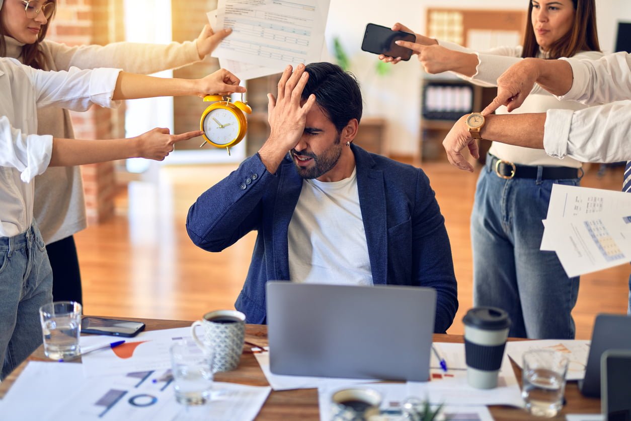 Group of business workers working together. Partners stressing one of them at the office